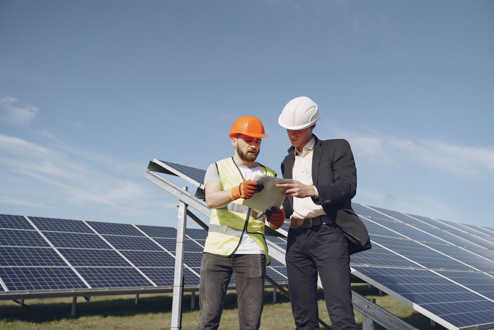 Engineers reviewing solar panel installation